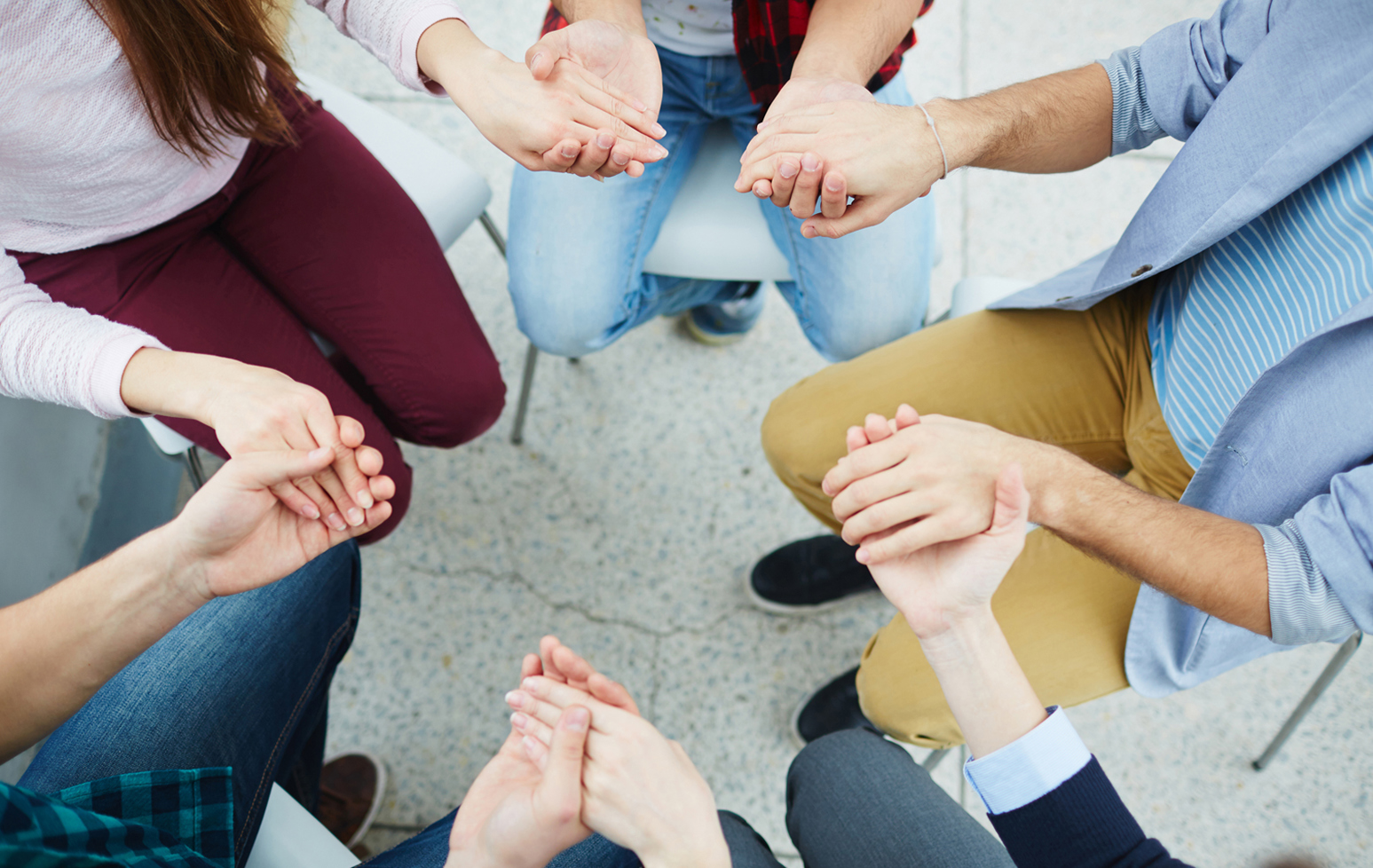 People holding hands in support_1696X1072 (1).jpg