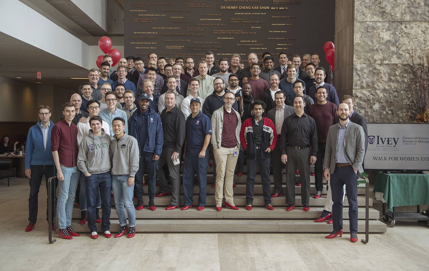 Ivey students, staff and faculty wearing red high heel shoes