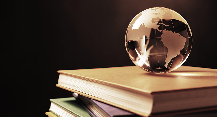 A glass globe sitting on some books