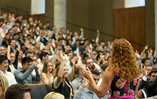 A woman speaking in an auditorium