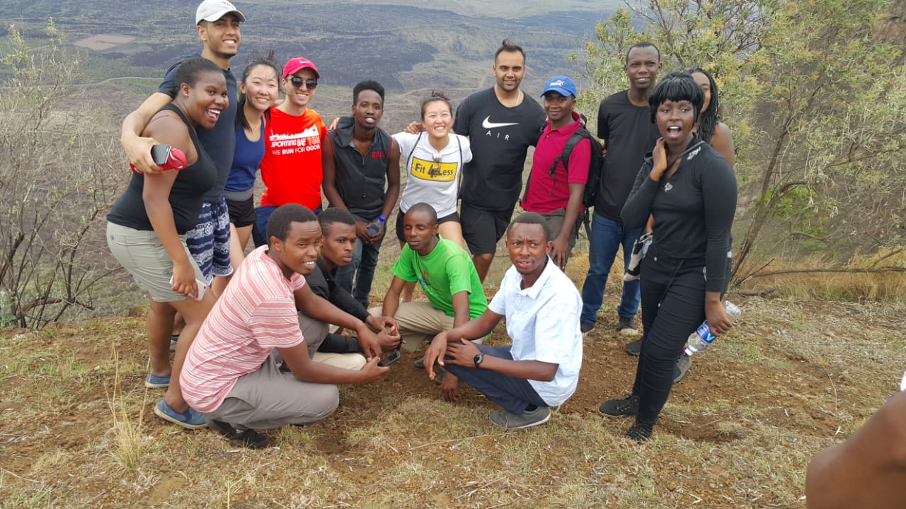 Students posing together on a hilltop