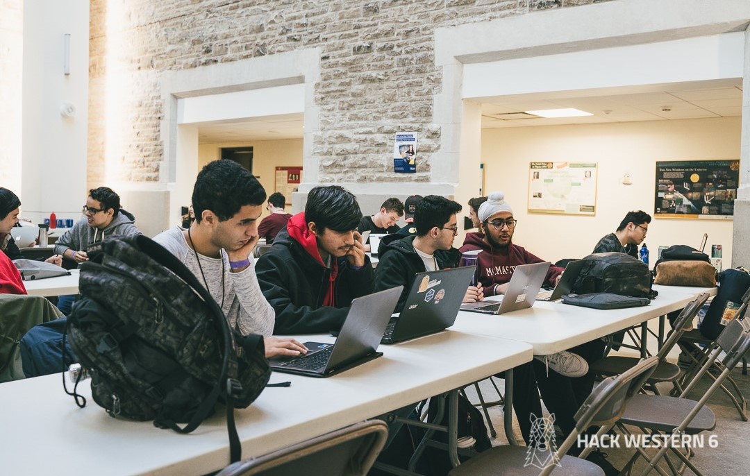 Group of students working on laptops at the Hack Western 6 event