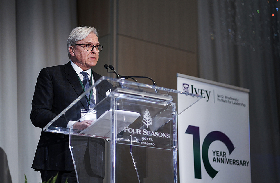 Ian O. Ihnatowycz speaking at a podium at an event