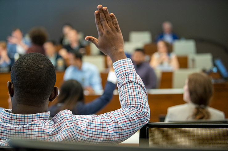 Student raising hand in class