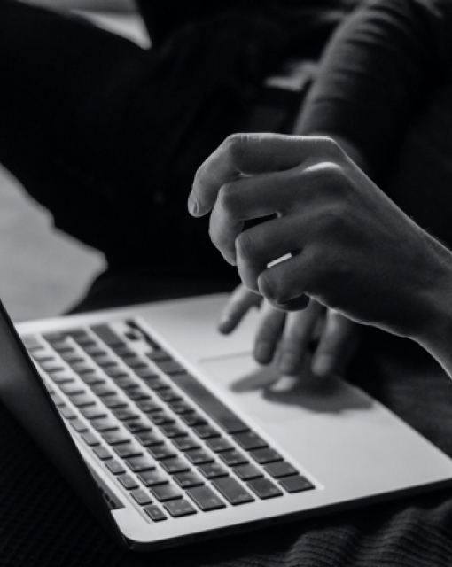 Hands Using A Trackpad On A Laptop