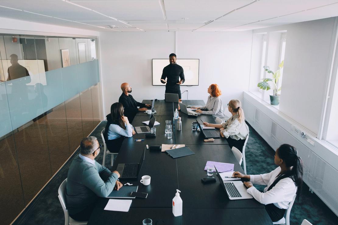 Person presenting at front of boardroom