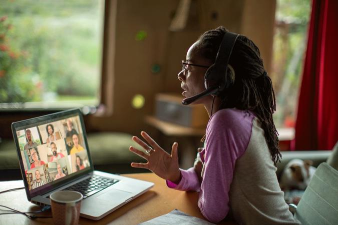 Woman speaking to team over virtual meeting