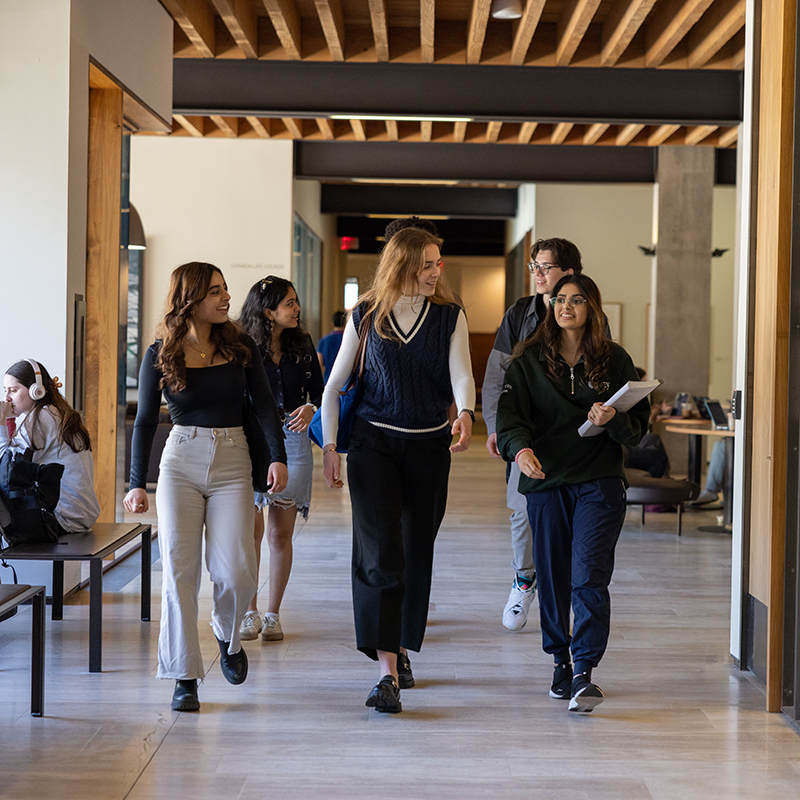 Five Students Walking Down The Hallway