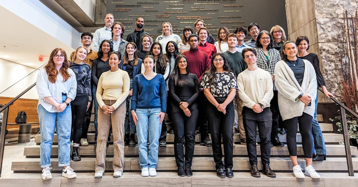 29 ESG In Action Students, Guests, And Faculty Stand On Ivey's Main Interior Steps, Smiling At Camera
