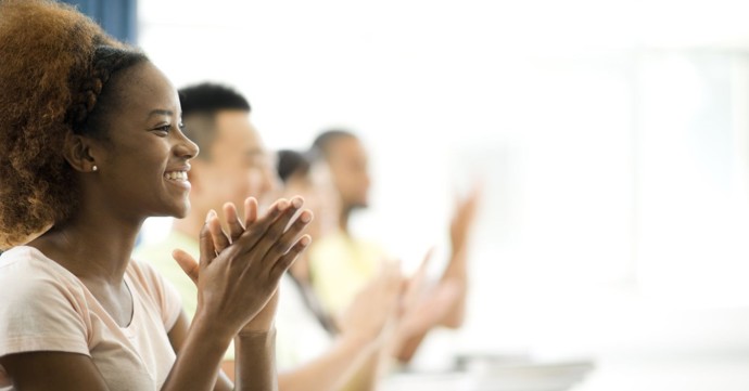 Students clapping hands in classroom