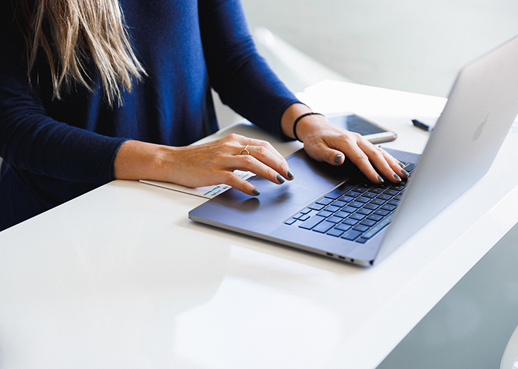 Woman typing on laptop