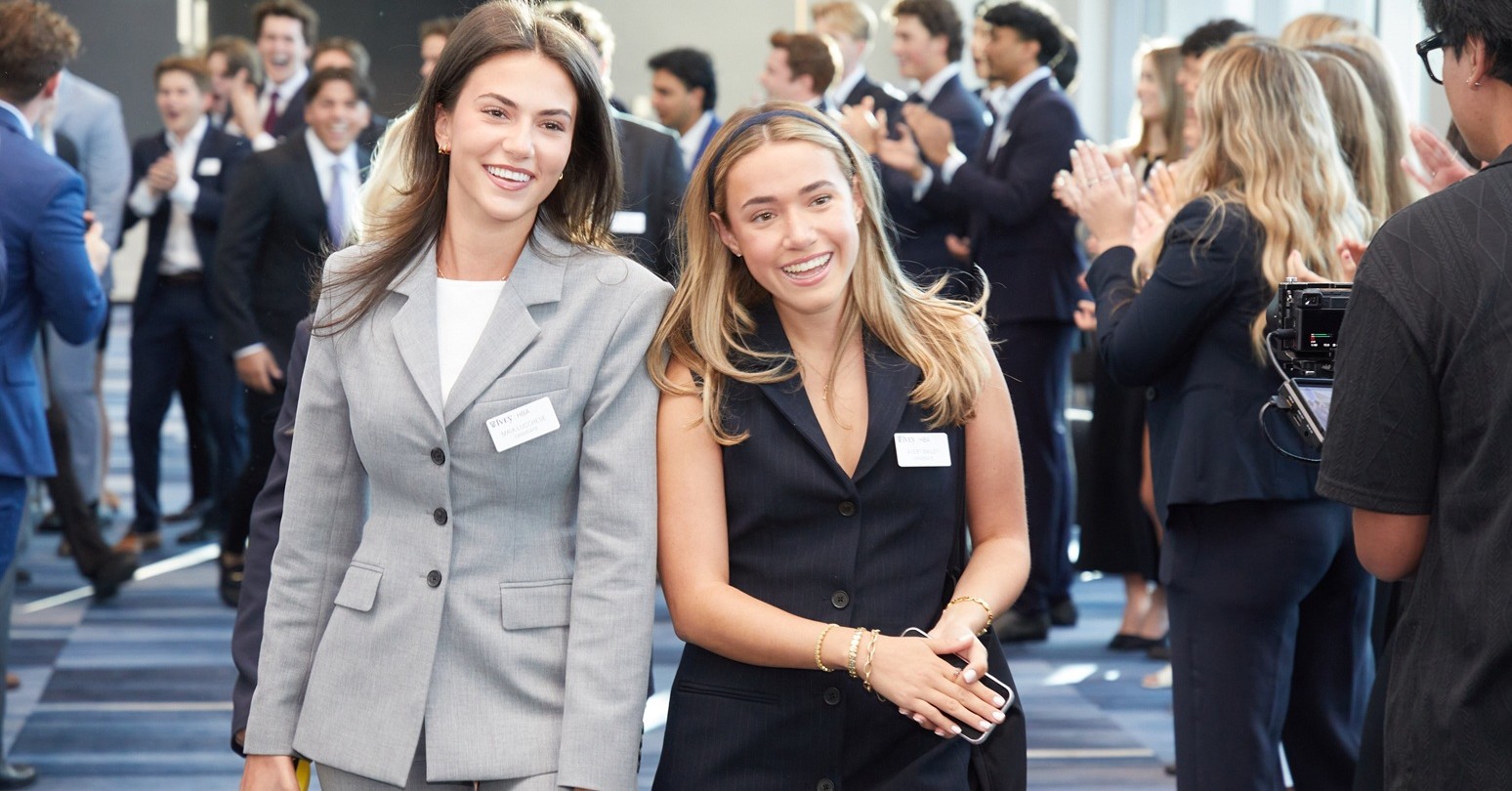 Two female HBA1 students being cheered on as they arrive at the Opening Gala