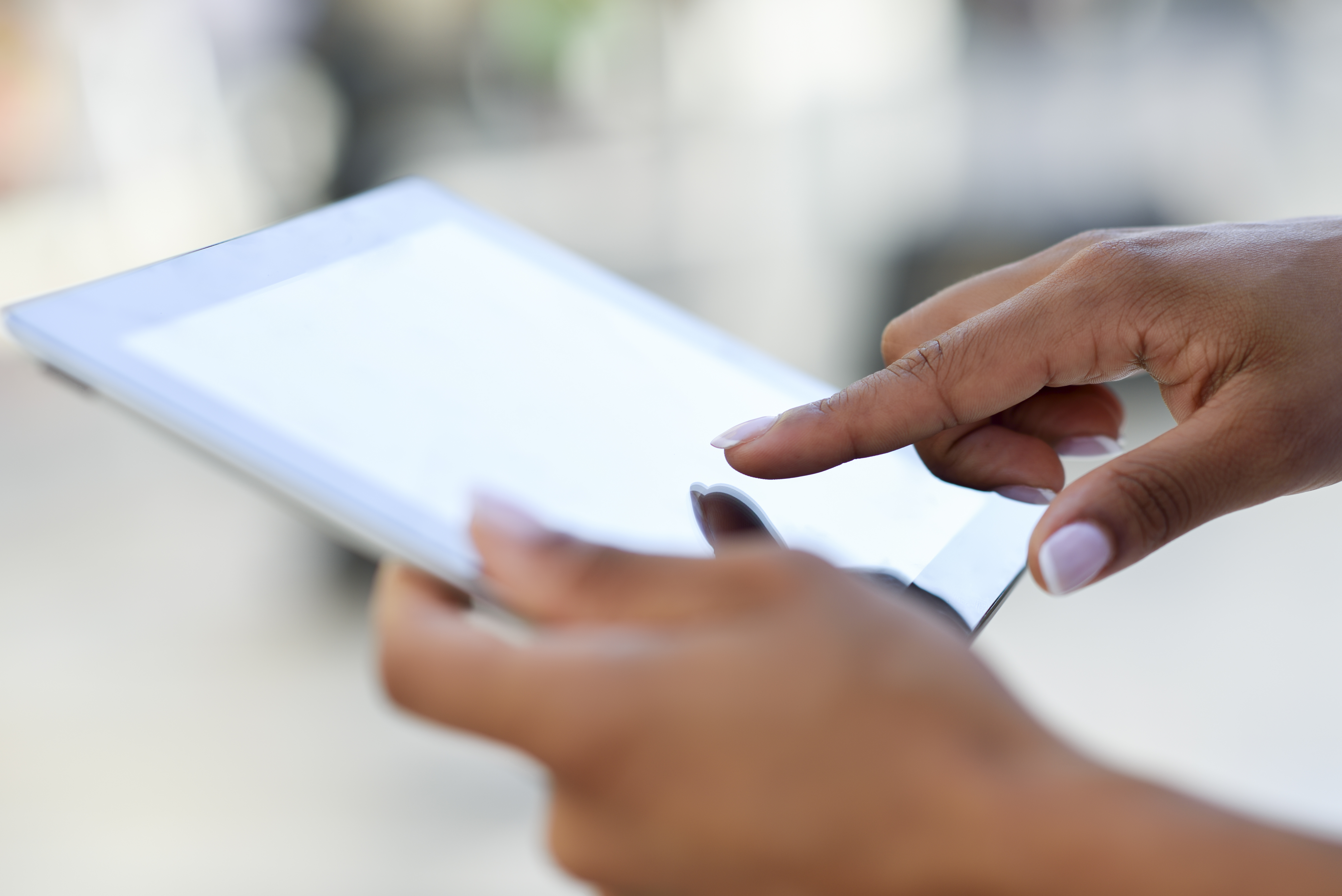 Hands Holding A Tablet