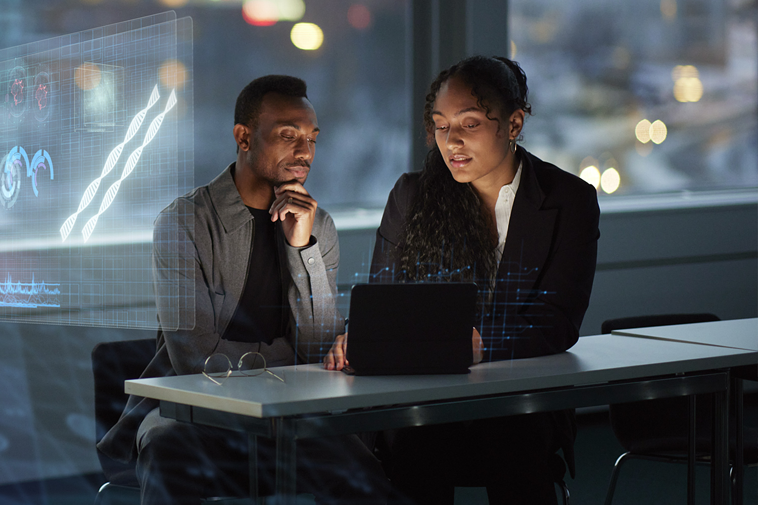 Two Executives Collaborating Around A Laptop