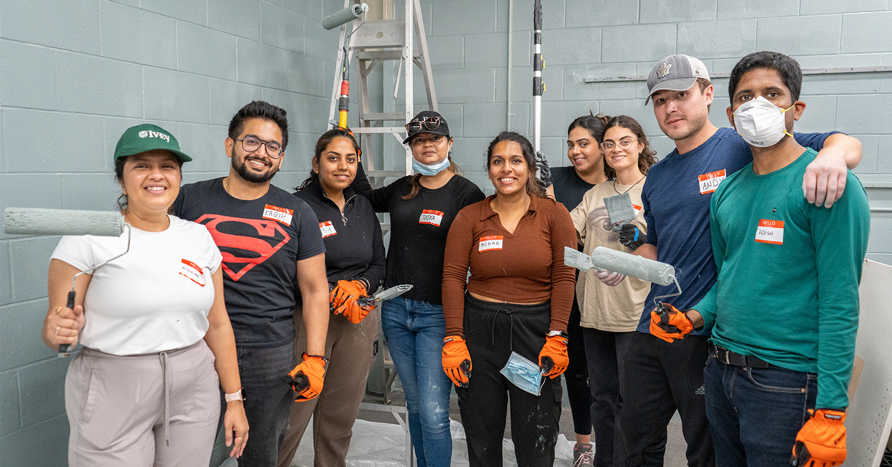 Ivey's MBA students painting at a Habitat for Humanity ReStore