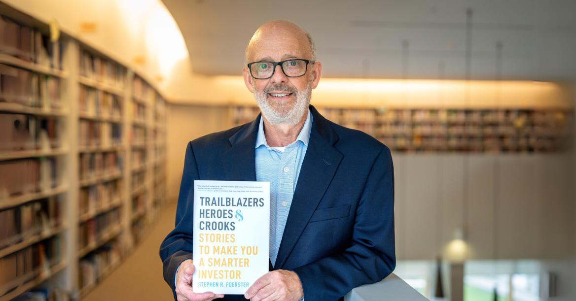 Stephen Foerster Holds Newly Published Book In Ivey Library Banner