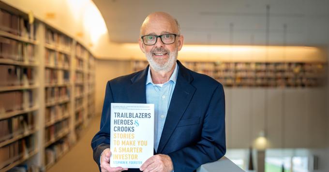 Stephen Foerster Holds Newly Published Book In Ivey Library Banner