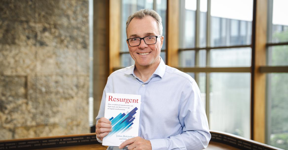 Photo Of Ivey Dean Birkinshaw Holding His New Book, Resurgent