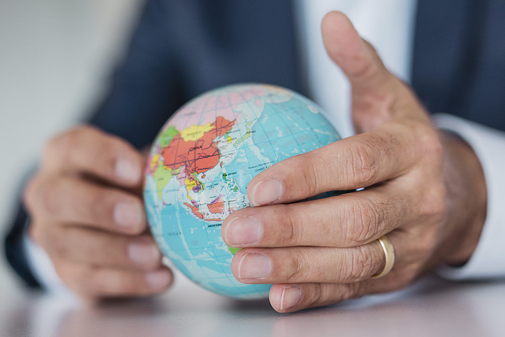 Hands holding a globe